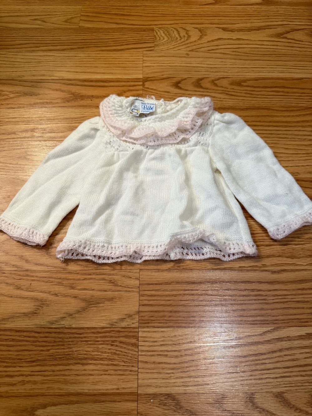 A vintage baby cardigan from the heritage brand Bébé by Cradlecraft.